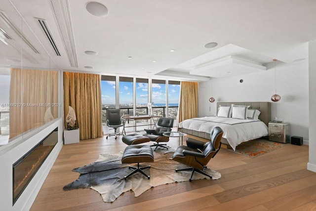 bedroom featuring light hardwood / wood-style flooring and expansive windows