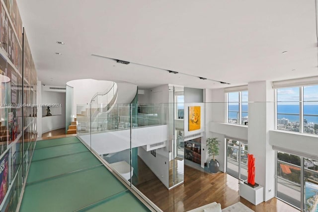 450 Alton Rd Unit Ph2, Miami Beach, FL 33139 - stairway featuring wood finished floors and a water view