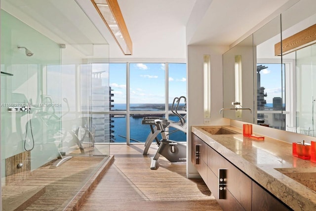 450 Alton Rd Unit Ph2, Miami Beach, FL 33139 - full bath featuring healthy amount of natural light, a stall shower, vanity, a water view, and floor to ceiling windows