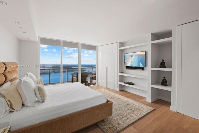 450 Alton Rd Unit Ph2, Miami Beach, FL 33139 - bedroom with access to exterior, light wood-style floors, and floor to ceiling windows