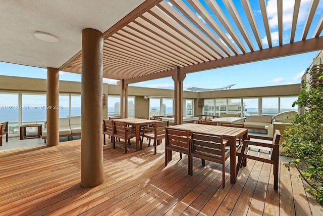 wooden terrace with a pergola and a water view