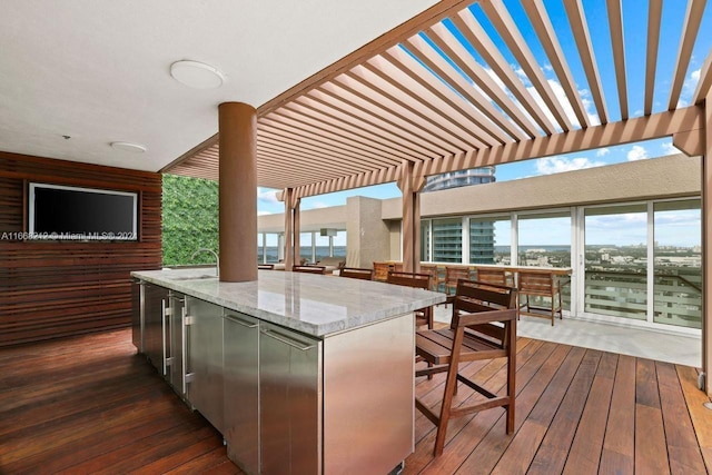 wooden deck featuring a pergola and a wet bar