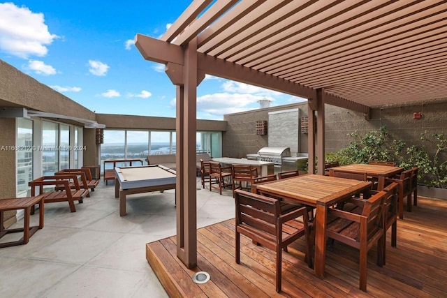 deck with area for grilling, a pergola, a water view, and a patio area