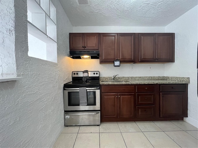 kitchen with stainless steel range with electric stovetop, a textured wall, range hood, a sink, and light tile patterned floors