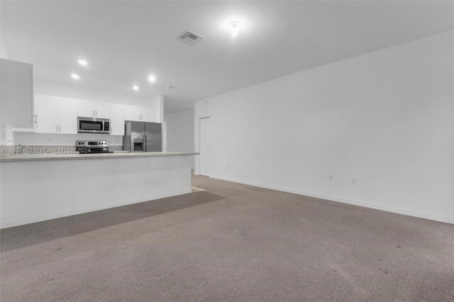 unfurnished living room with light carpet