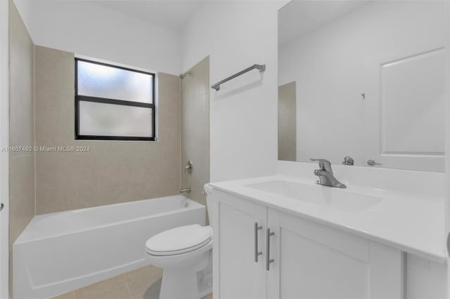 full bathroom featuring tile patterned flooring, vanity, tiled shower / bath combo, and toilet