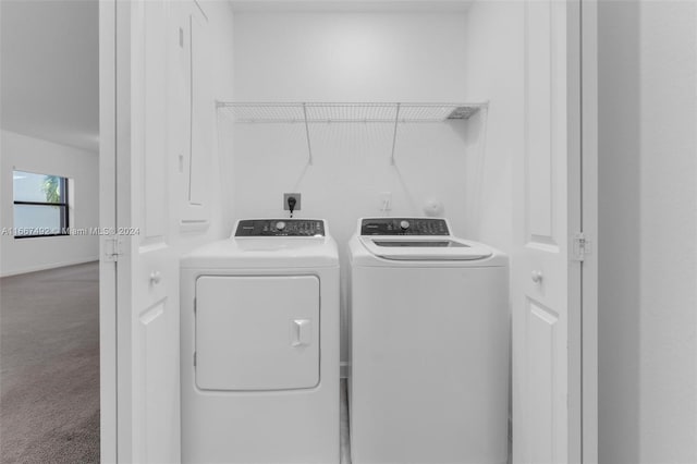 clothes washing area featuring carpet and independent washer and dryer