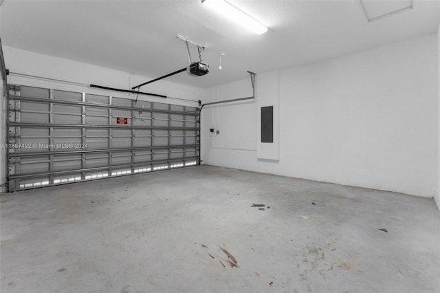 garage featuring electric panel and a garage door opener