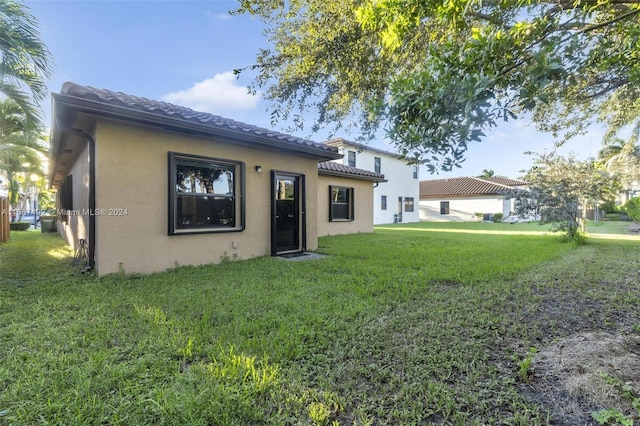 rear view of house with a lawn