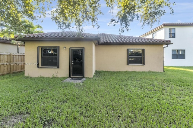 back of house with a lawn