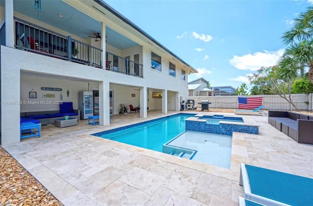 view of pool featuring an in ground hot tub, ceiling fan, grilling area, and a patio area