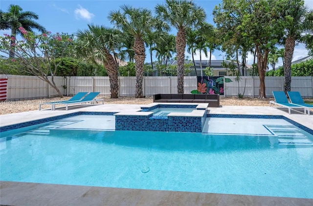 view of swimming pool featuring an in ground hot tub and a patio