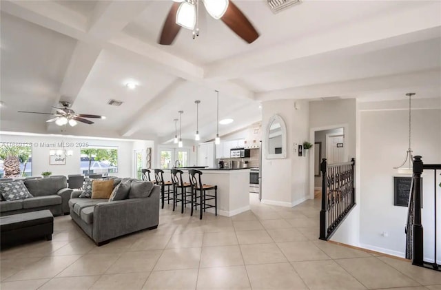 tiled living room with ceiling fan and lofted ceiling with beams