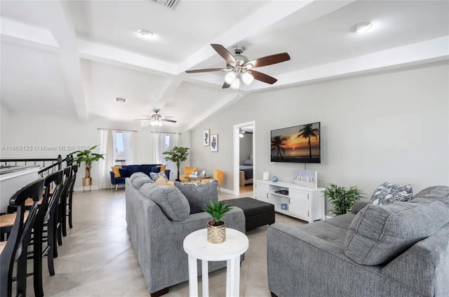 living room with light tile patterned flooring and vaulted ceiling with beams