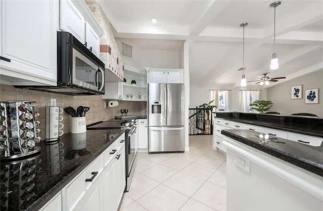 kitchen with appliances with stainless steel finishes, white cabinets, pendant lighting, dark stone counters, and backsplash