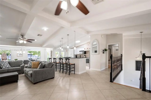 living room featuring light tile patterned flooring, vaulted ceiling with beams, and ceiling fan