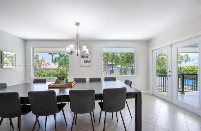 tiled dining area featuring french doors, a chandelier, and a wealth of natural light