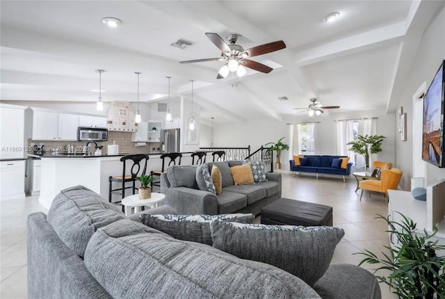 living room featuring lofted ceiling with beams and light tile patterned flooring