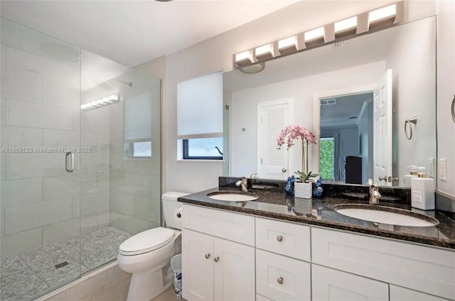 bathroom with vanity, tile patterned flooring, a shower with shower door, and toilet