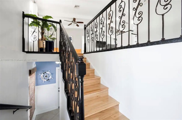 stairs with ceiling fan