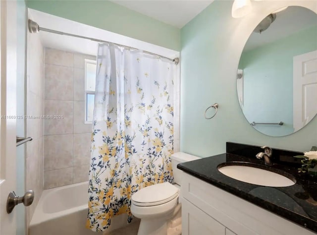 full bathroom with vanity, shower / bath combo, and toilet