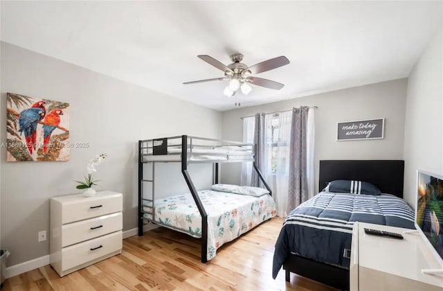 bedroom with ceiling fan and light hardwood / wood-style flooring