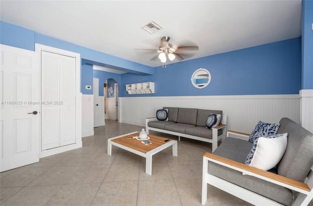 living room with light tile patterned floors and ceiling fan