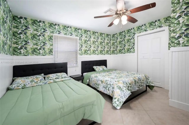 tiled bedroom with a closet and ceiling fan