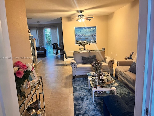 living room with ceiling fan and light tile patterned floors