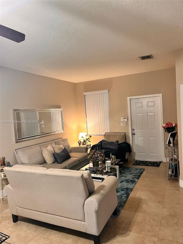 tiled living room with a textured ceiling