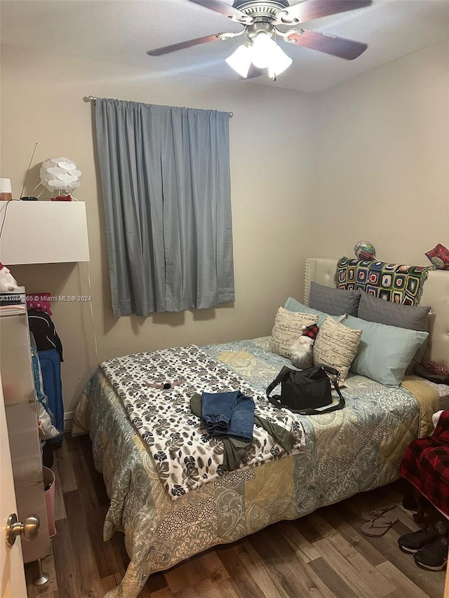 bedroom featuring hardwood / wood-style flooring and ceiling fan