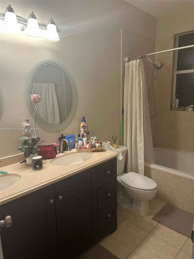 full bathroom with shower / bath combo, toilet, vanity, and tile patterned floors