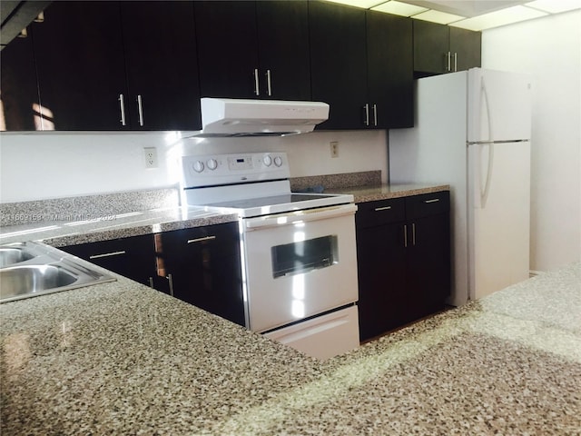 kitchen with white appliances and range hood