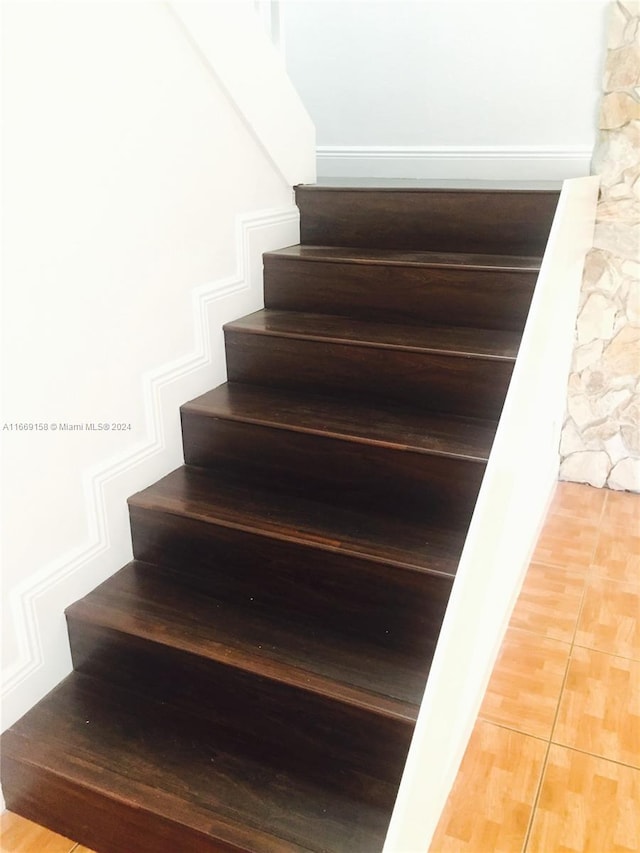 staircase with hardwood / wood-style floors