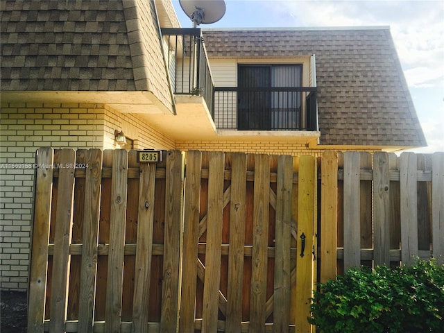8205 SW 23rd Ct Unit 21A, North Lauderdale, FL 33068 - view of home's exterior featuring brick siding, roof with shingles, and mansard roof