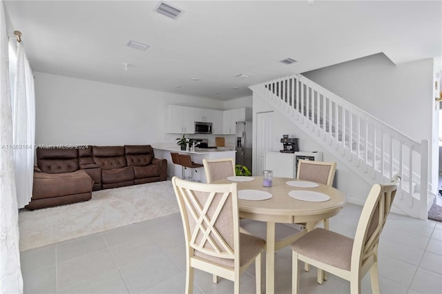 dining area with light tile patterned floors