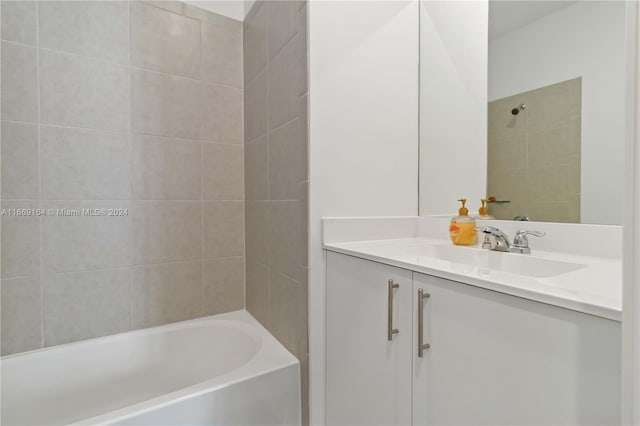 bathroom with vanity and tiled shower / bath combo