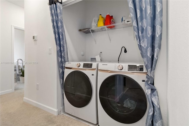 laundry area with light colored carpet and washing machine and dryer