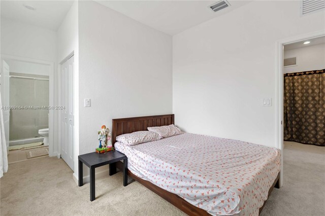 carpeted bedroom with ensuite bath