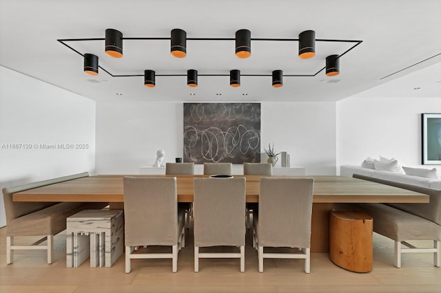 dining space with hardwood / wood-style flooring