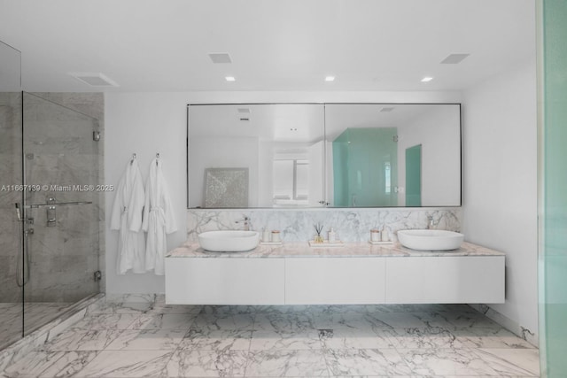 bathroom featuring vanity and an enclosed shower