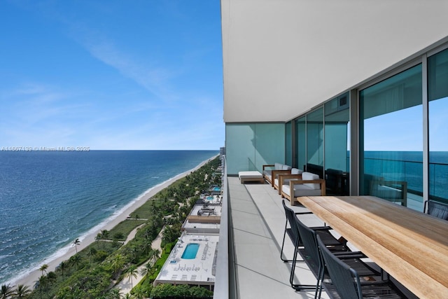 balcony with a water view and a beach view