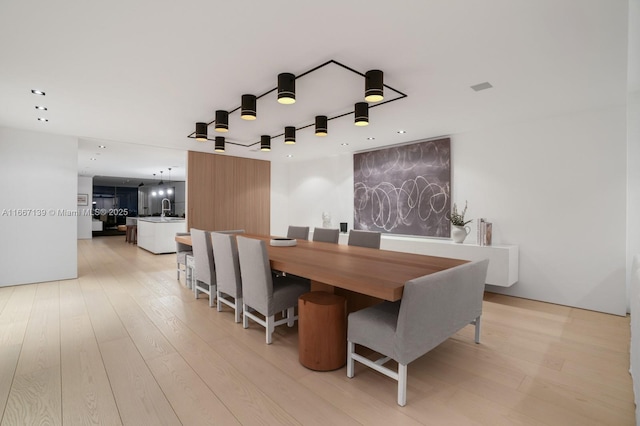 dining room featuring light wood-type flooring and sink