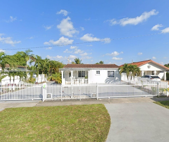 441 E 37th St, Hialeah, FL 33013 - view of front of house featuring a fenced front yard, driveway, and a gate