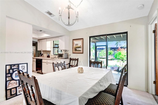 dining area featuring a textured ceiling, sink, a notable chandelier, lofted ceiling, and light carpet