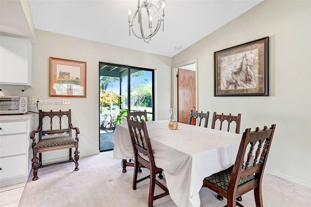 carpeted dining space with lofted ceiling, a textured ceiling, and a chandelier