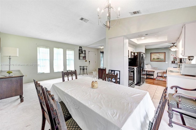 dining area with a textured ceiling, ceiling fan, and light hardwood / wood-style flooring