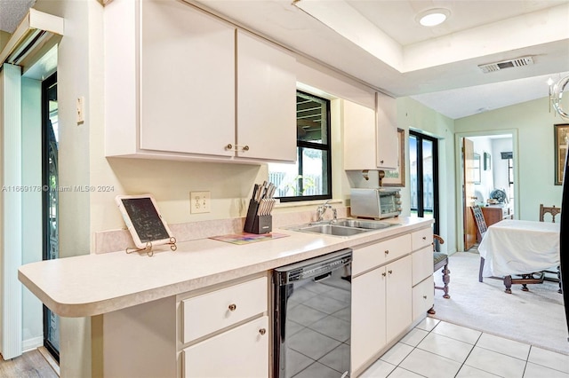 kitchen with white cabinets, kitchen peninsula, dishwasher, sink, and light carpet