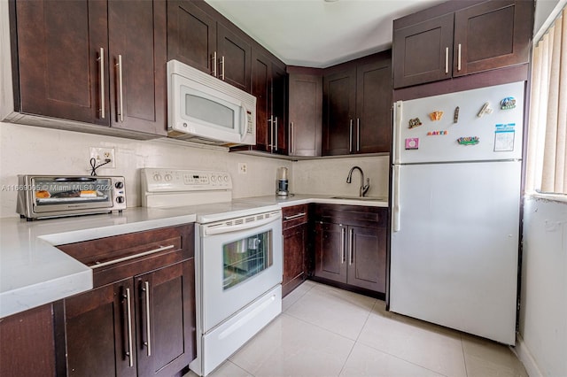 kitchen featuring light tile patterned flooring, sink, white appliances, tasteful backsplash, and dark brown cabinets