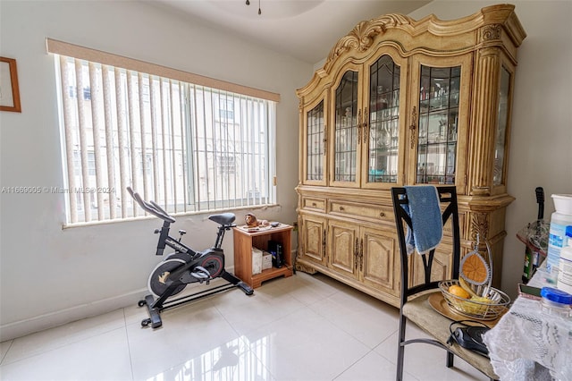 workout room with light tile patterned flooring